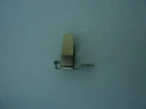 Metallene Türfeder von Remeha, in einfacher Form mit einem kleinen Hebel an der Seite, für die Befestigung an Türmechanismen.